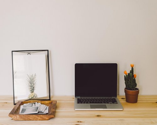 Home office setup near a large window letting in natural daylight