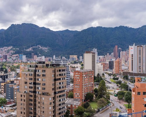 View from a window looking at the mountains in Bogota